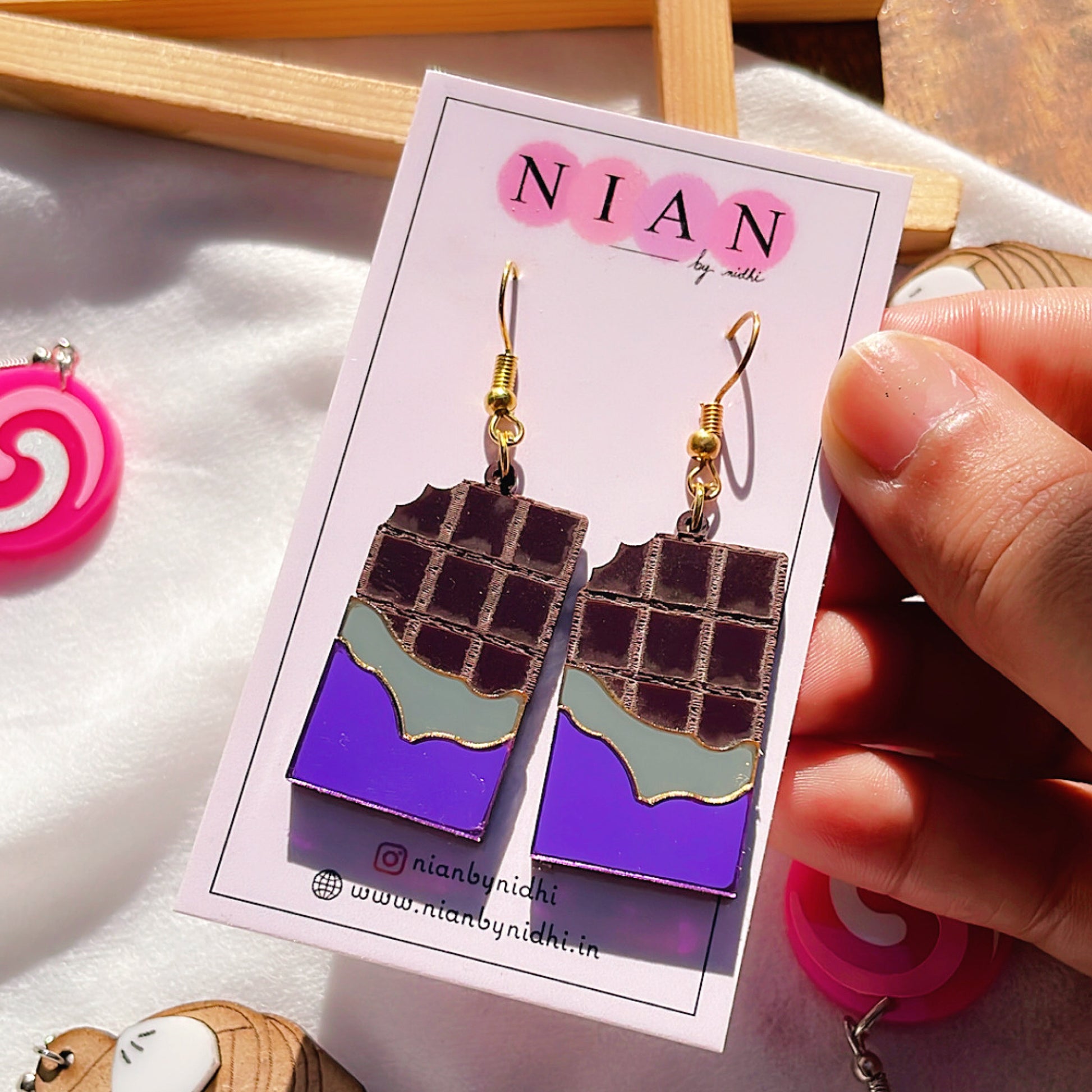 Choco Candy Earrings - Purple and Brown - Nian by Nidhi - placed in a white background, held in a woman's hand