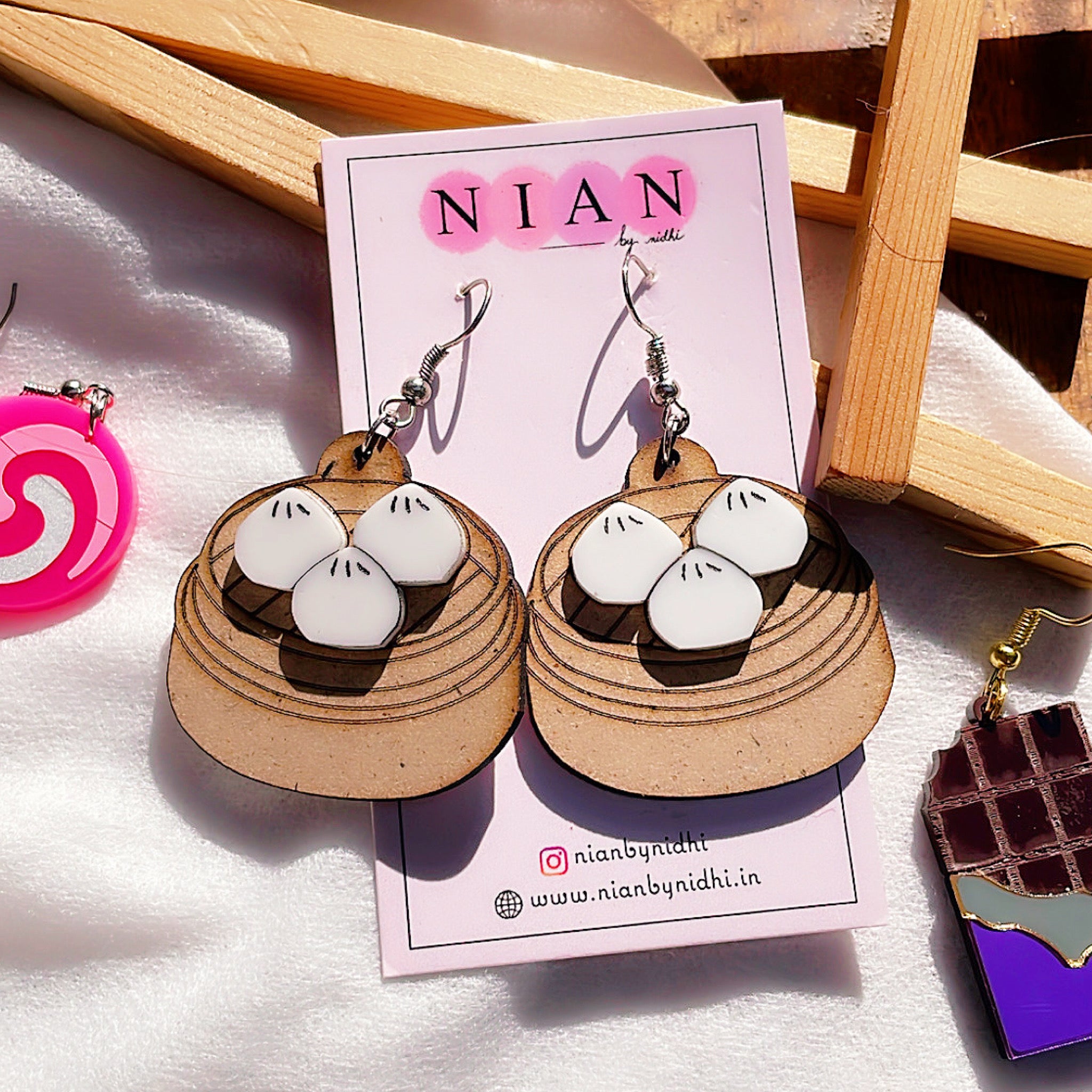Momos Earrings - White and Brown - Nian by Nidhi - placed in a white and brown background