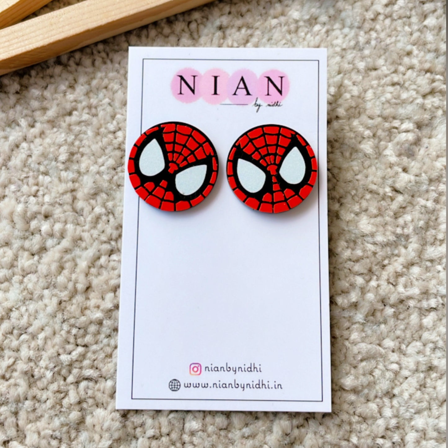 Spider-Man Studs - Nian by Nidhi - placed in a light beige background
