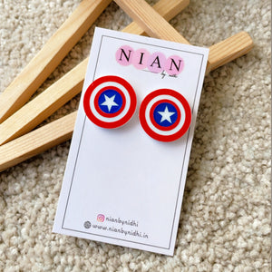 Captain America Studs - Nian by Nidhi - placed in a light beige background