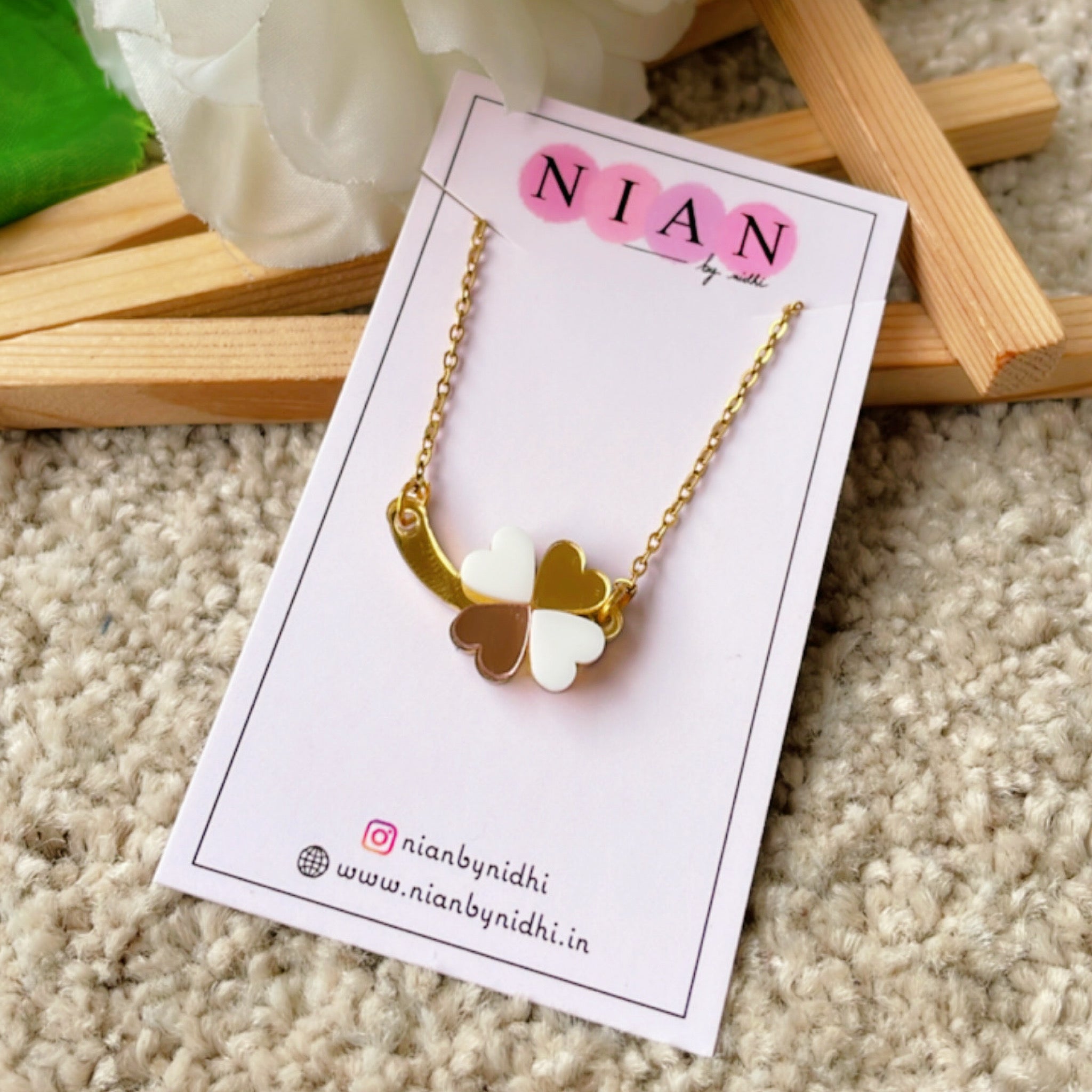 Clover Necklace - White, Rosegold, and Golden - Nian by Nidhi - placed on a Nian by Nidhi product card, in a light beige background