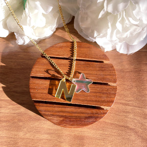 Customised Initial Necklace - with "N" and a Star, Golden and holographic, Nian by Nidhi - in a white and brown background