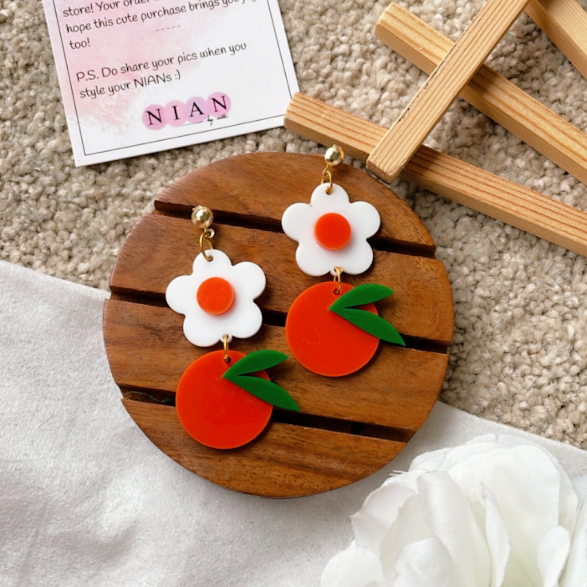 Orange Blossom Earrings - Orange and White - Nian by Nidhi - placed in a white and light beige background