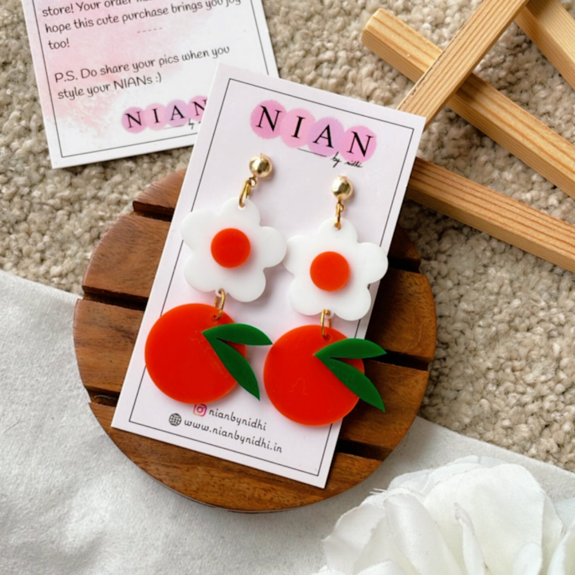 Orange Blossom Earrings - Orange and White - Nian by Nidhi - placed in a white and light beige background
