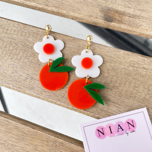 Orange Blossom Earrings - Orange and White - Nian by Nidhi - placed in a white and light beige background