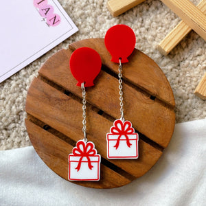 Balloon Gift Earrings - White and Red - Nian by Nidhi - placed in a brown and white background