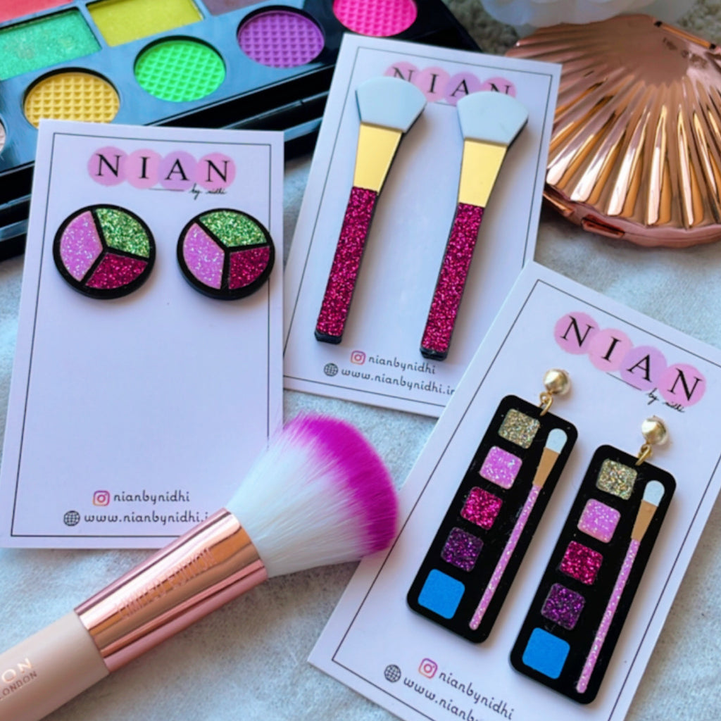 Makeup Earrings (Set of 3) - Consists Makeup Palette Earrings, Makeup Brush Earrings, and Glitter Blush Earrings - Nian by Nidhi - placed along with real makeup material