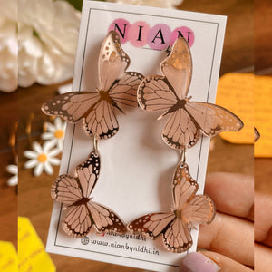 Butterfly Earrings - Glossy Rosegold - Nian by Nidhi - held in a hand