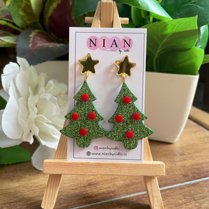 Xmas Tree Earrings - Shimmer Green and Red - Nian by Nidhi - placed on a small wooden canvas, inside a Nian by Nidhi Earring card