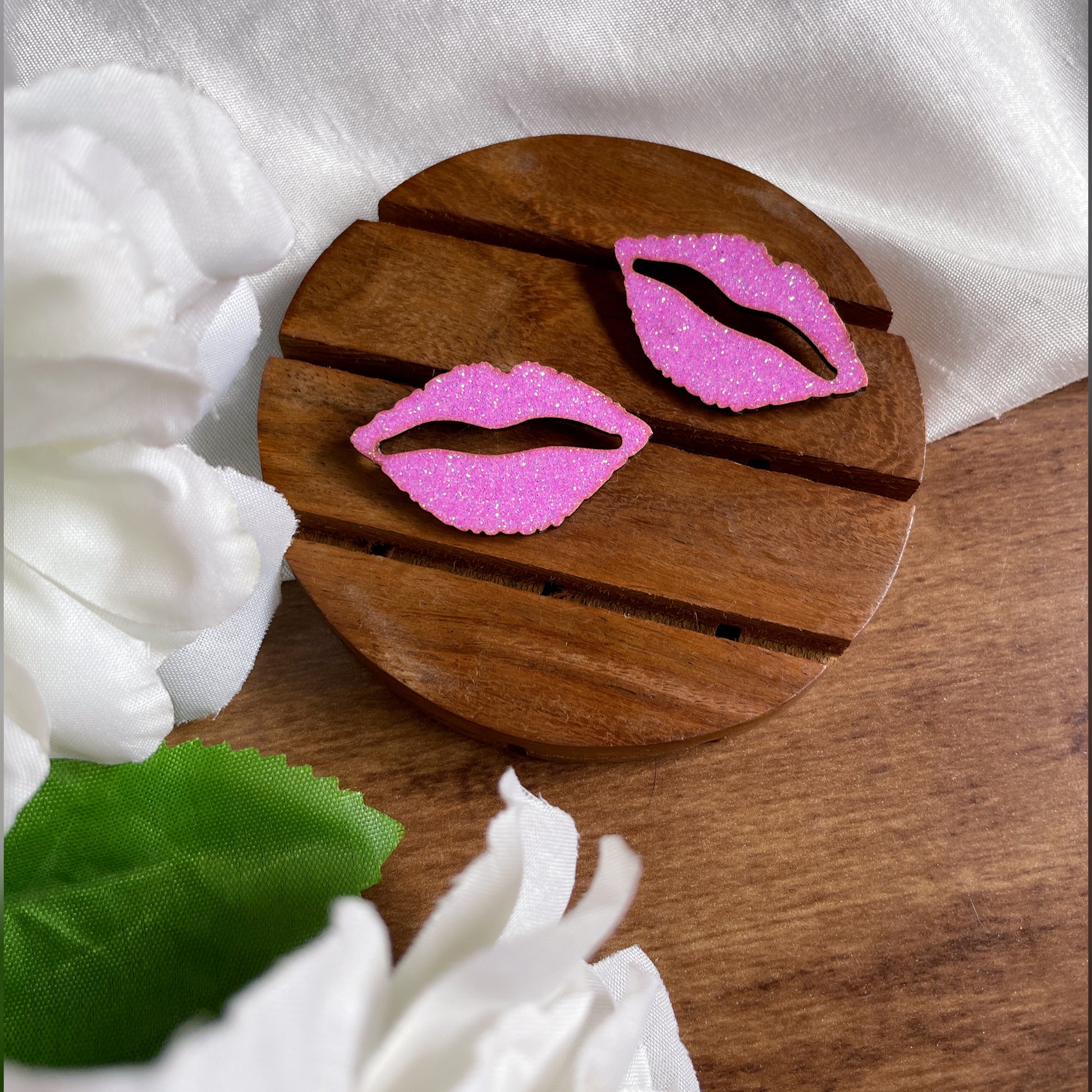 Shimmer Lips Studs - Pink - Nian by Nidhi - in a white, green, and brown background