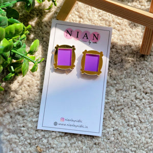 Monica's Frame Studs - Purple and Golden - Nian by Nidhi - placed in a light beige background