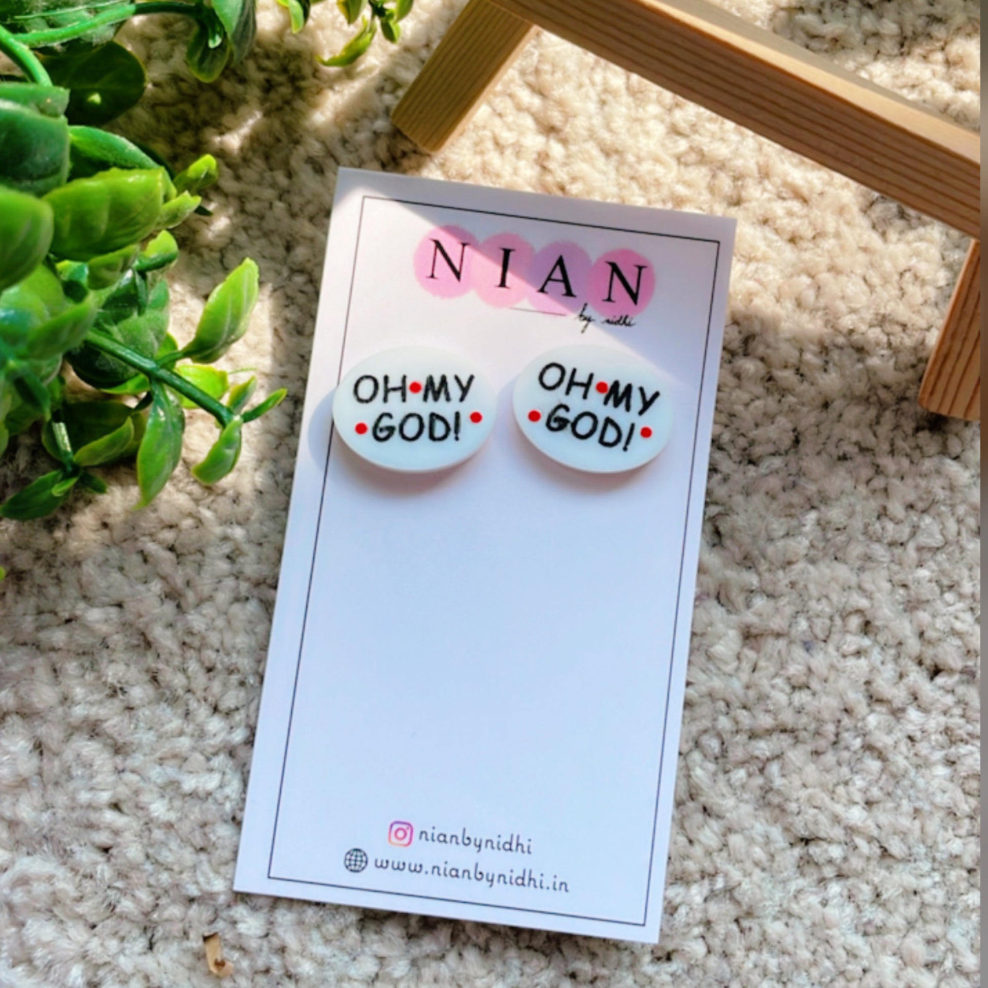 Oh My God Studs - White - Nian by Nidhi - placed in a light beige background