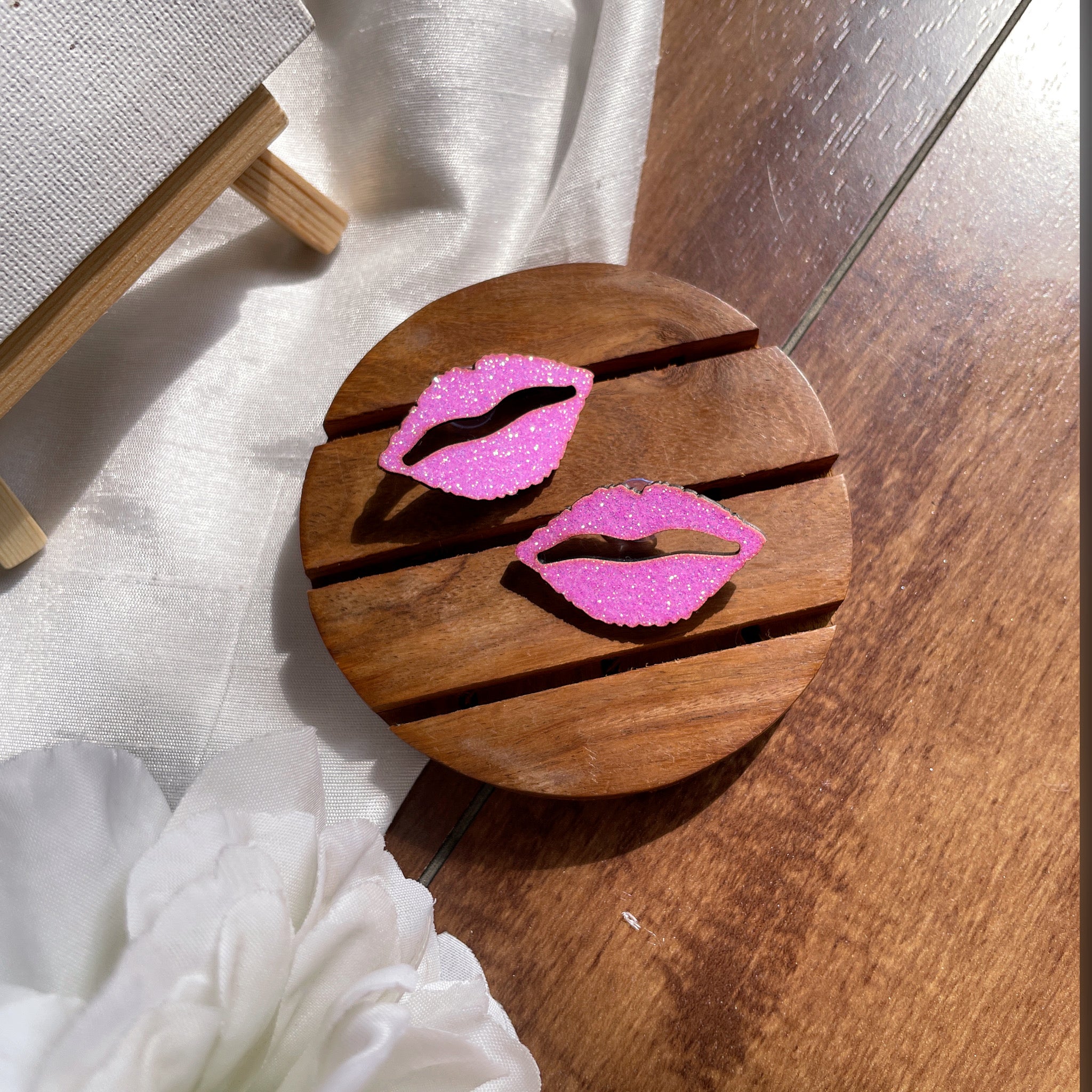 Shimmer Lips Studs - Pink - Nian by Nidhi - in a white and brown background, as well as a plain white canvas