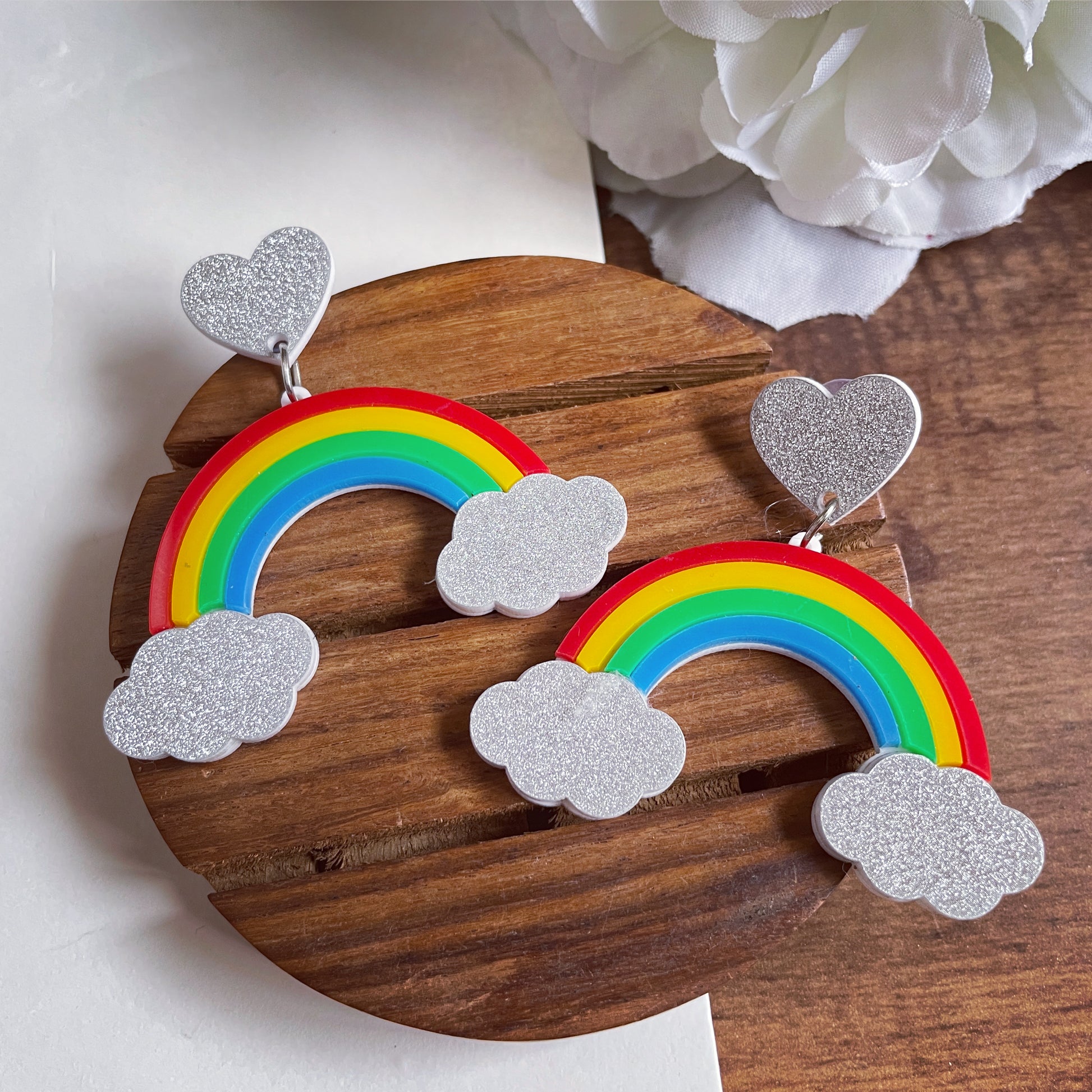 Rainbow Earrings - multi color - Red, Yellow, Green, and Blue - Silver clouds and hearts - Nian by Nidhi - in a white and brown background
