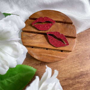 Shimmer Lips Studs - Red - Nian by Nidhi - in a white, green, and brown background