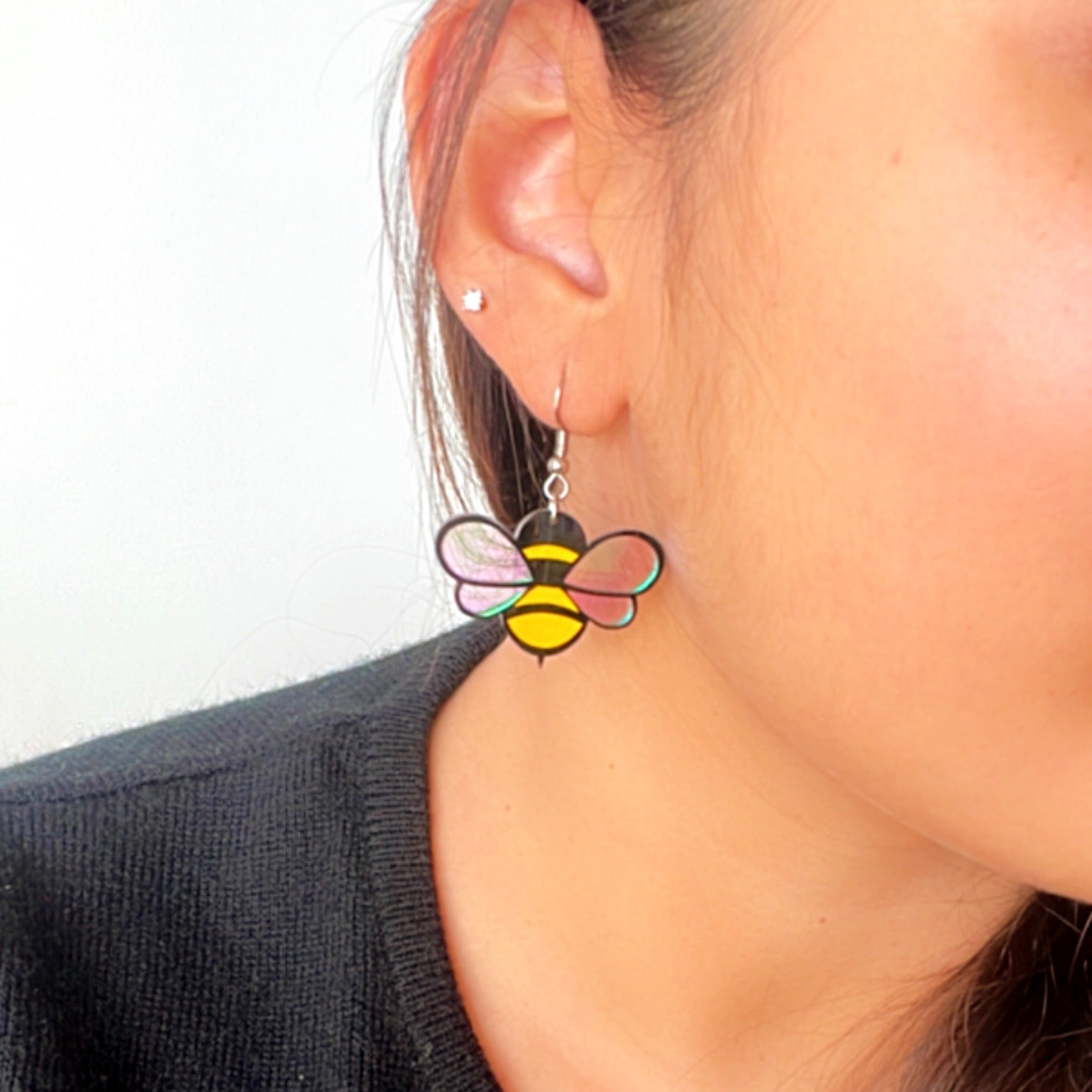 Baby Bee Earrings - Yellow and Black with a Holographin Effect - Nian by Nidhi - worn by a woman